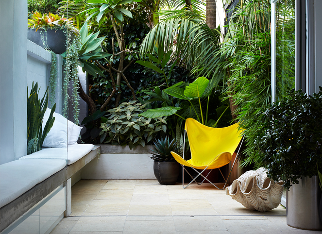 Courtyard garden design featuring tropical planting, built-in seating and a private outdoor retreat