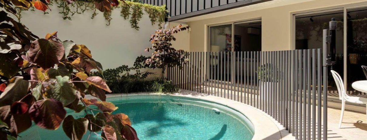 Custom plunge pool design in Sydney featuring a modern circular swimming pool, contemporary pool fencing and landscaped courtyard.