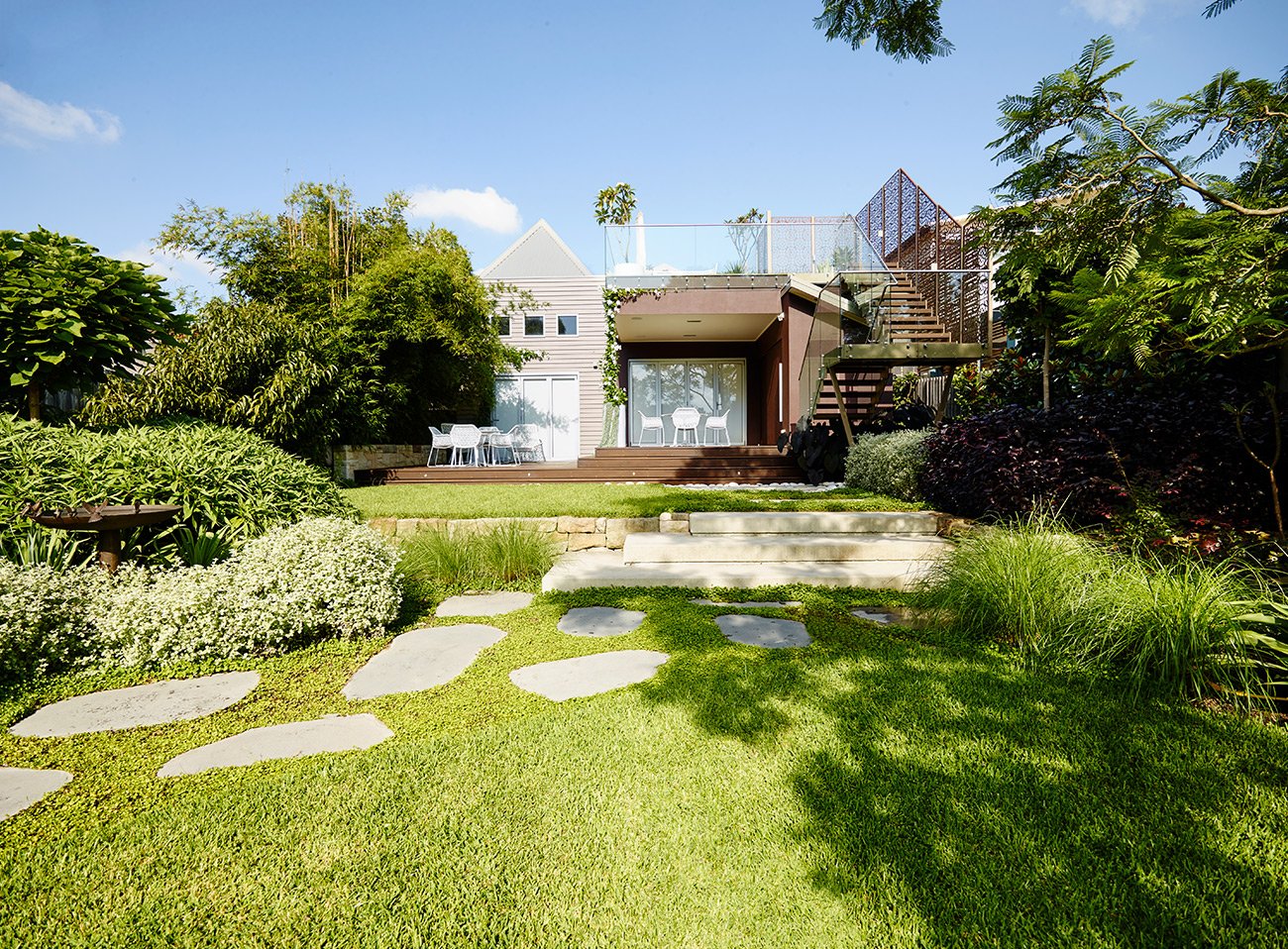 Landscape and garden design in Maroubra with stepping stones, lawn and layered coastal planting
